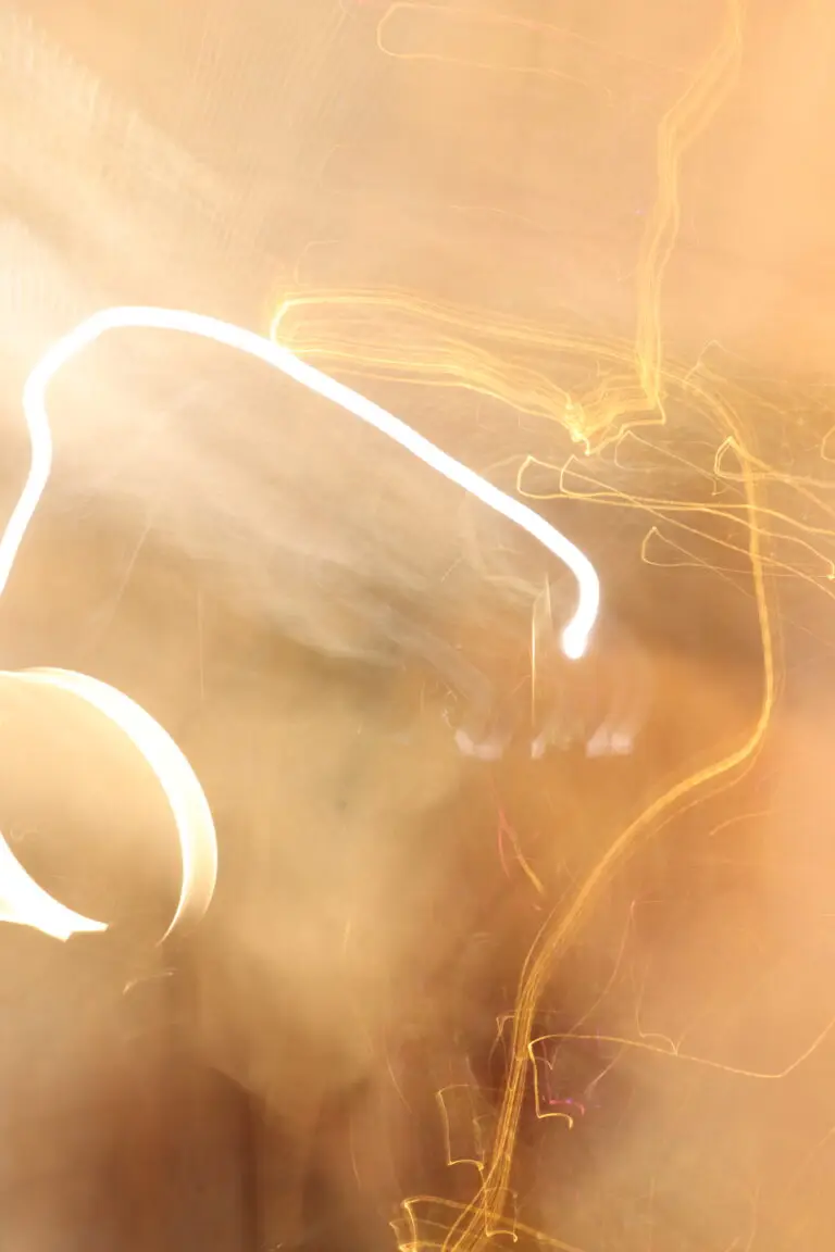 Warm-toned abstract image with curved glowing light streaks