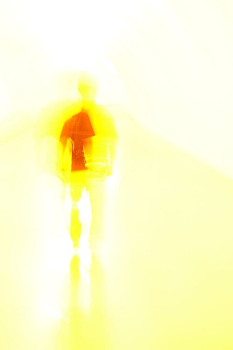 Glowing silhouette of a person into the bright yellow light