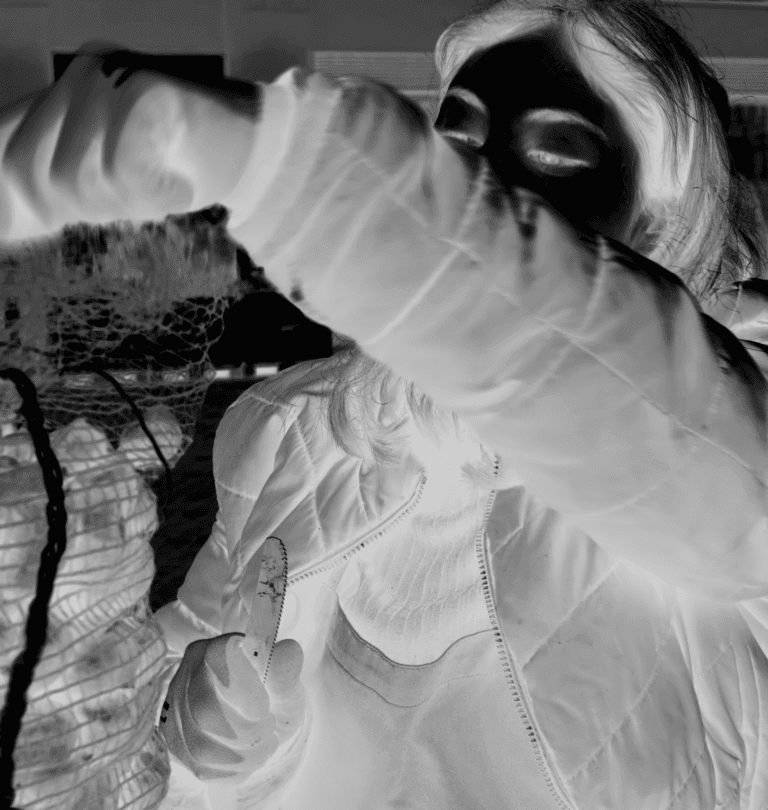 Inverted black-and-white image of two people embracing